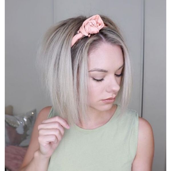 A girl with her straight bob hairstyle with rose headband