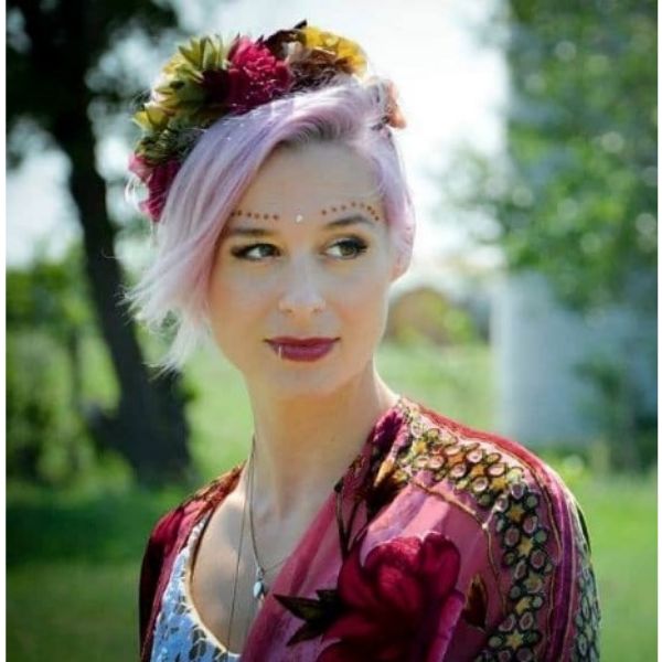 a woman with Short Pink Pixie wedding hairstyles for short hair With Frida Kahlo inspired Head Piece