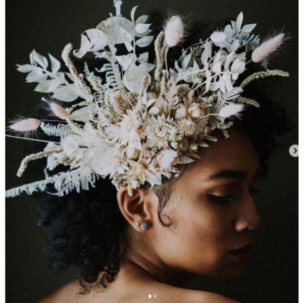 a woman with Curly Hair With Side Floral Headpiece