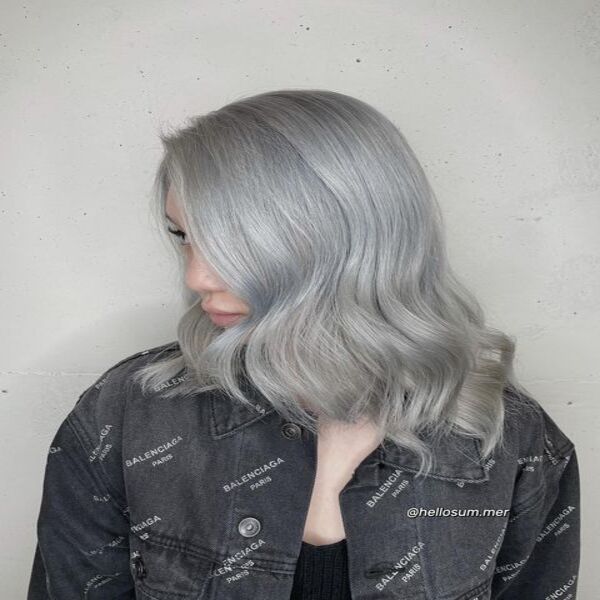 Medium Wavy Grey Silver Hair - A woman wearing A grey top