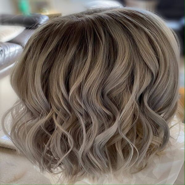Cute Ashy Balayage Bob Hairstyle - A woman wearing with a chair as background