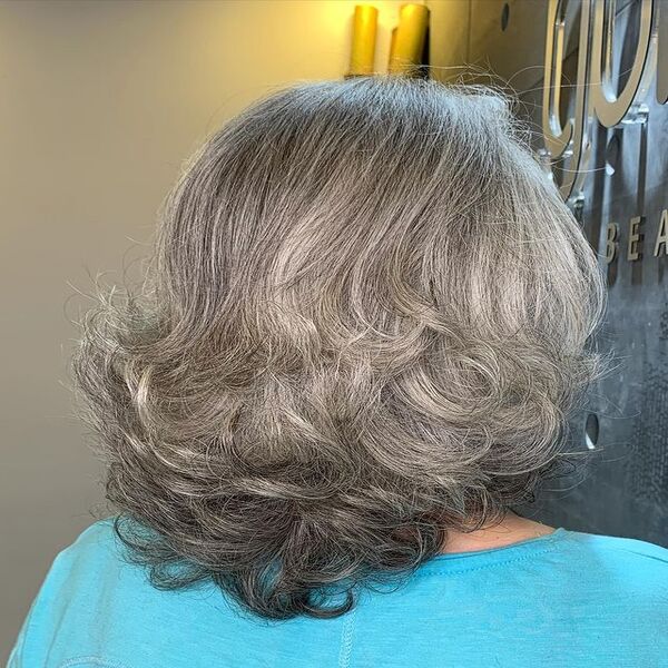 Dark Black Silver Grey Ring Curls Hair - A woman wearing in a light blue shirt