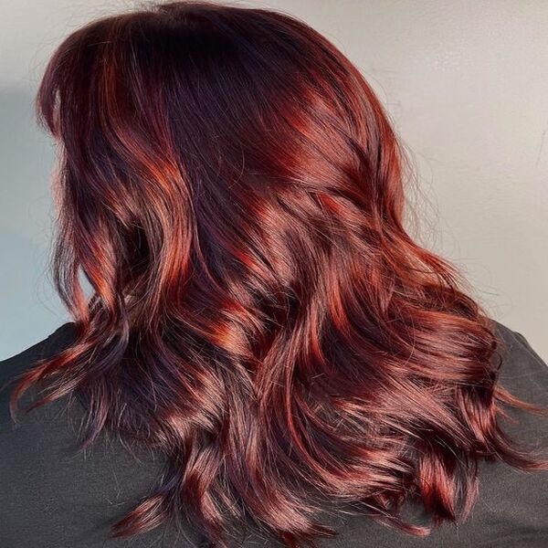 Deep Brown Red Auburn Hair - A woman wearing a black salon cape