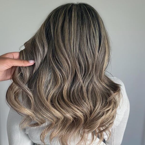 Grey Ash Blonde Balayage - A woman in her white sweater