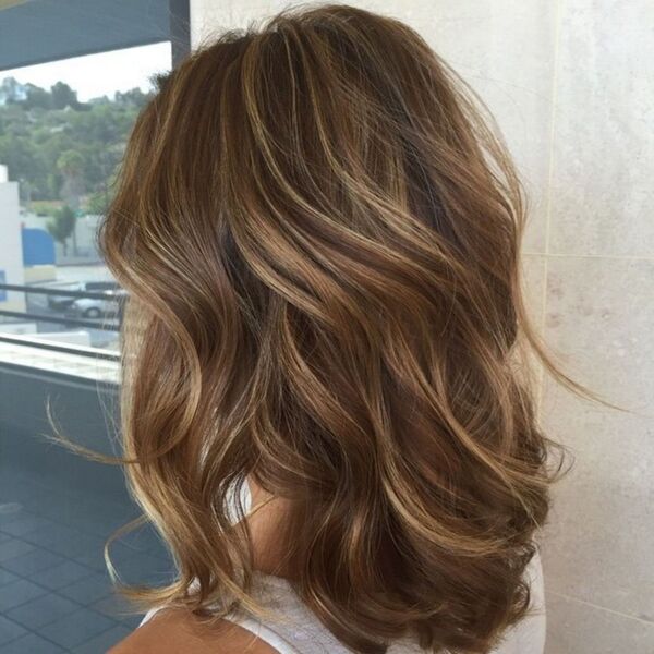 Sandy Balayage on Light Brown Medium Hair - A woman in a white rounded sleeveless