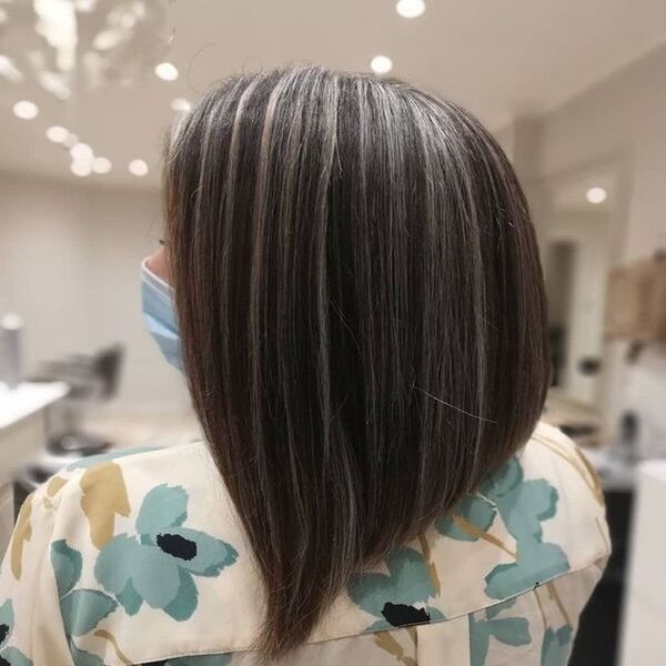 Bubbly Pitch Dark Hair with Grey Highlights - A woman in her flowery top