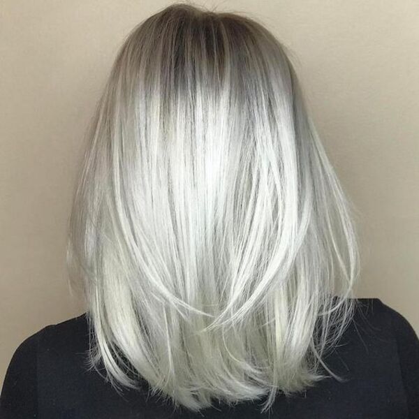 Metallic Silver Hair Perfect for Summer - A woman in facing a wall