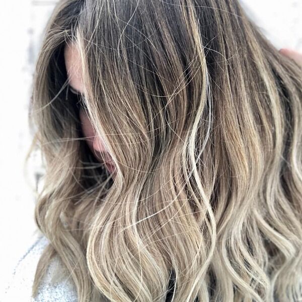 3D Balayage with Platinum Highlights - a woman wearing a gray blouse