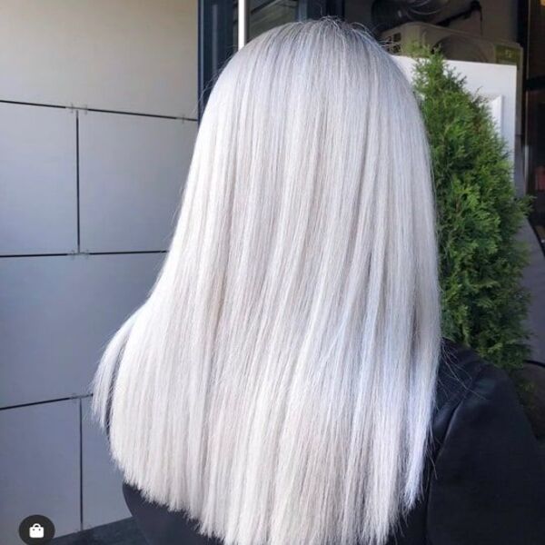 Icy Platinum Blonde for One Length Mid Hair - A woman in black shiny top