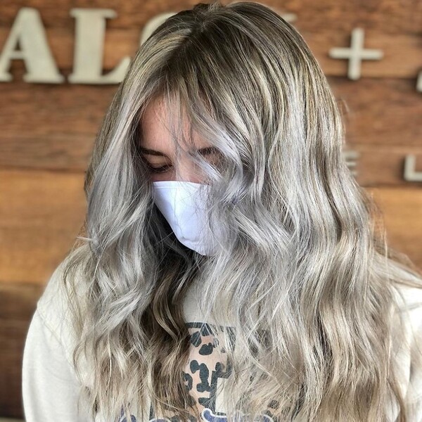Ash Blonde With Platinum Highlights - a woman wearing a white facemask