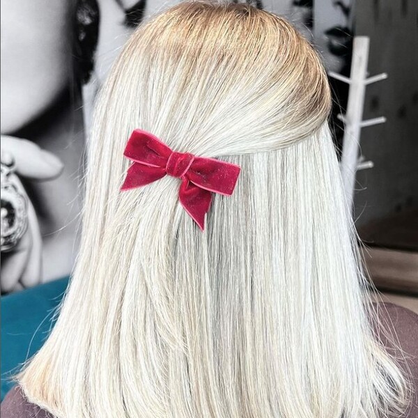 Ashy White Tone - a woman wearing a red ribbon on her hair