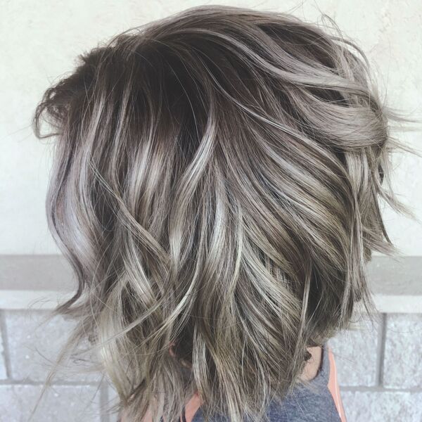 Beige Highlights on a Gray Blonde bob - a woman wearing an orange and gray shirt