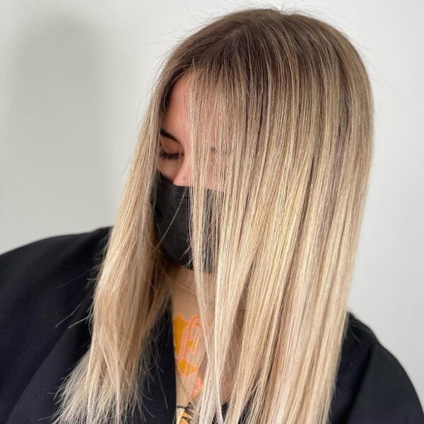 Blonde Balayage Straight Hair - a woman wearing a black facemask and a black blouse