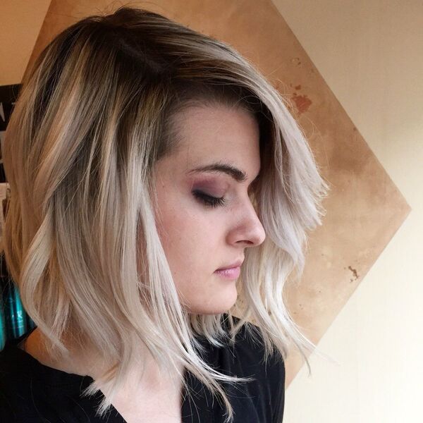 Blonde Balayage with Shadow Roots - a woman with a full make up on