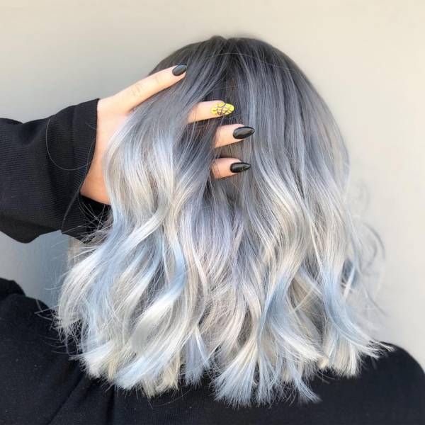 Blue Tinted Platinum Hair - a girl with long black nails holding her hair