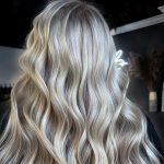 Boho Chic Sandy Blonde Hairstyle - a female wearing a black cape