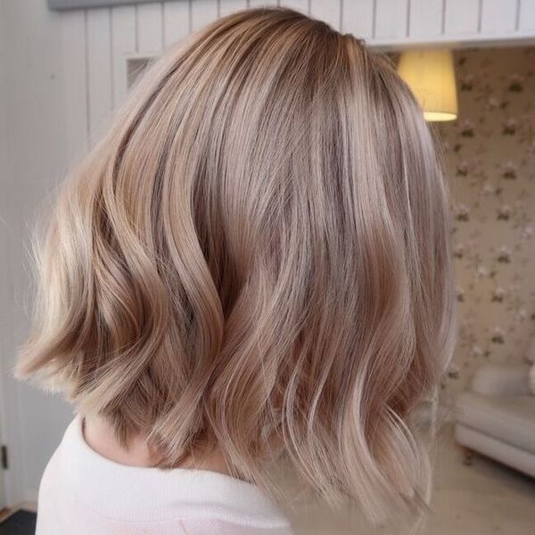 Champagne Blonde Bob Hair - a girl wearing a white shirt