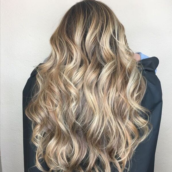 Extra-Long Balayage Waves - a woman in a black barber's cape