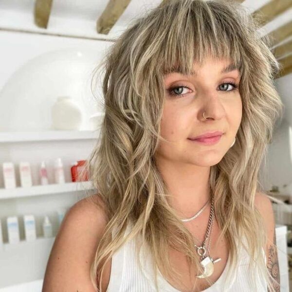 Gorgeous Light Blonde Wolf Hair - a woman wearing a white sleeveless shirt and has piercing in her nose