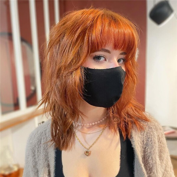 a woman wearing a black facemask and a bunch of necklaces - Hot Orange Wolf Haircut Short