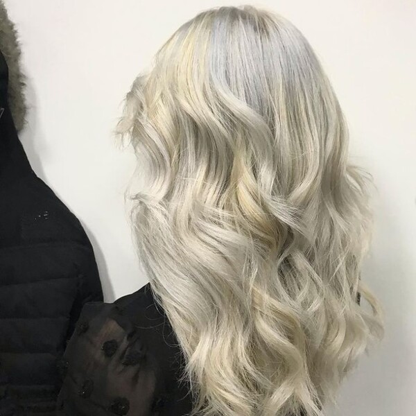 Icy Ash Blonde - a woman facing a thick coat
