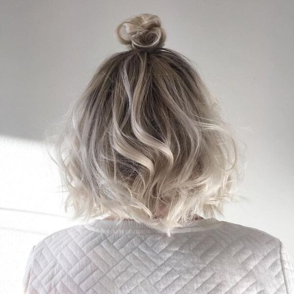 Nordic Ash Blonde - a woman wearing thick jacket and bun some of her hair
