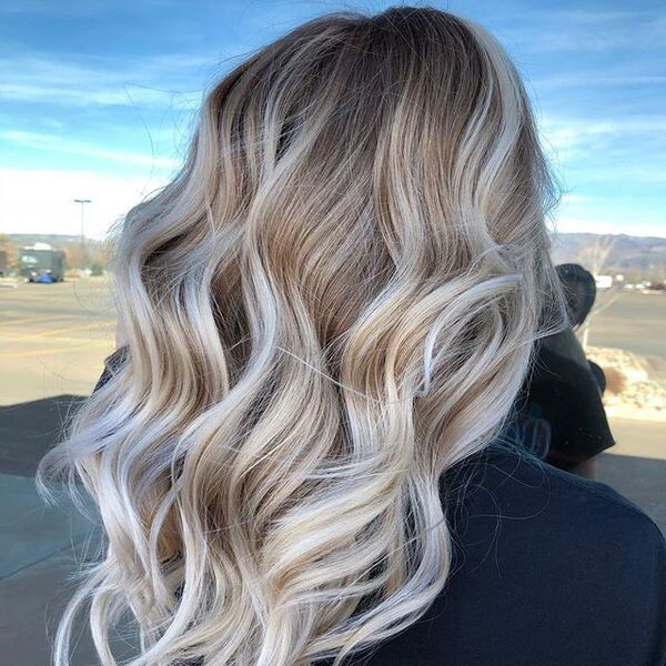 Platinum Blonde Highlights on Brown hair - a woman wearing a black shirt