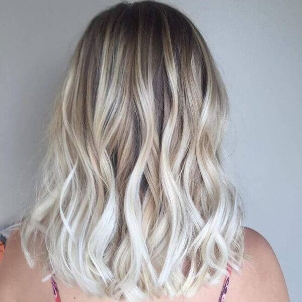 Platinum Blonde Ombre on Brown Hair - a woman wearing a spaghetti strap blouse