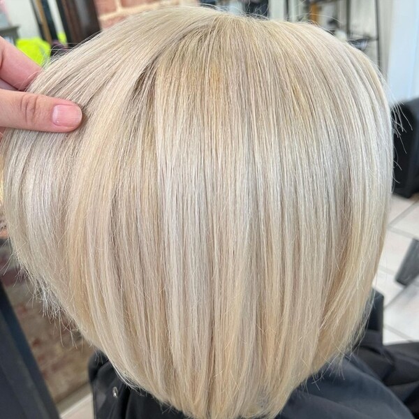 Platinum Blonde for Short Hair - a woman wearing a black cape