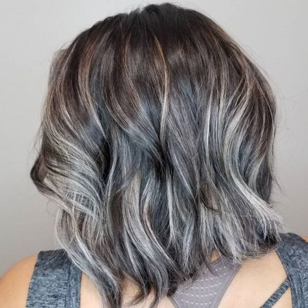 Platinum Blonde with Dark Lowlights - a woman wearing a gray sleeveless shirt