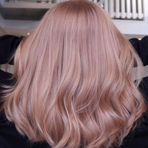 Rose Gold Platinum Blonde Hair - woman wearing a black jacket