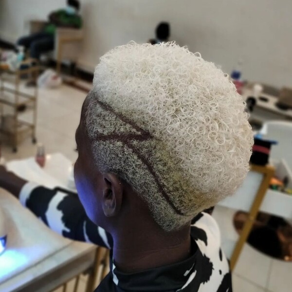 Shaved and Curly Platinum White Hair - a black american woman wearing a black & white printed shirt