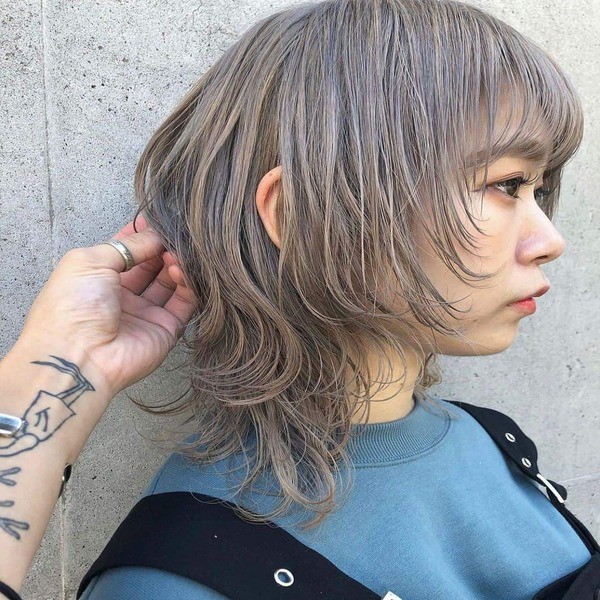 Spicy Grey Bob Wolf Haircut - a Korean girl wearing a blue shirt and a black jumpsuit