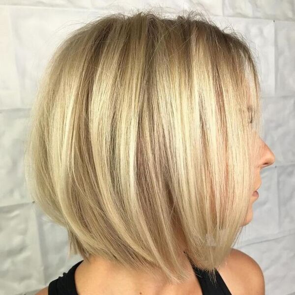 Warm Platinum Blonde on Fine Hair - a woman wearing a black sando shirt