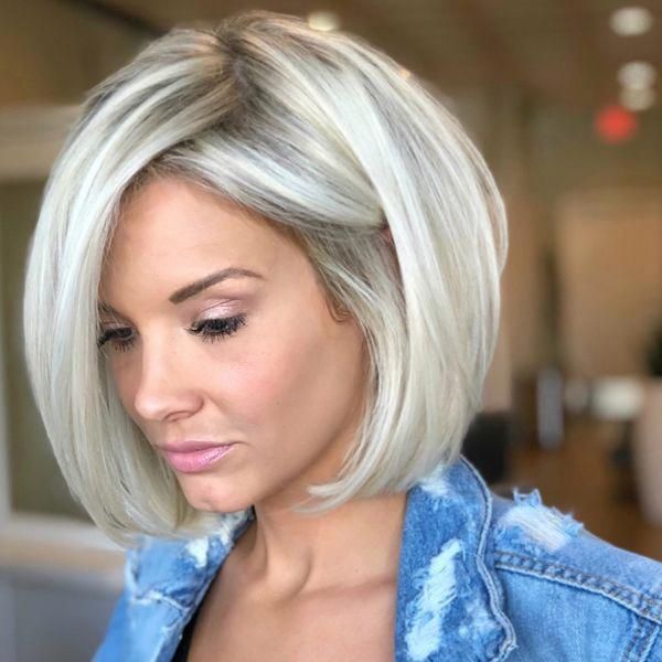 Zero-Elevation Icy Blonde Bob - a woman wearing a denim tattered jacket