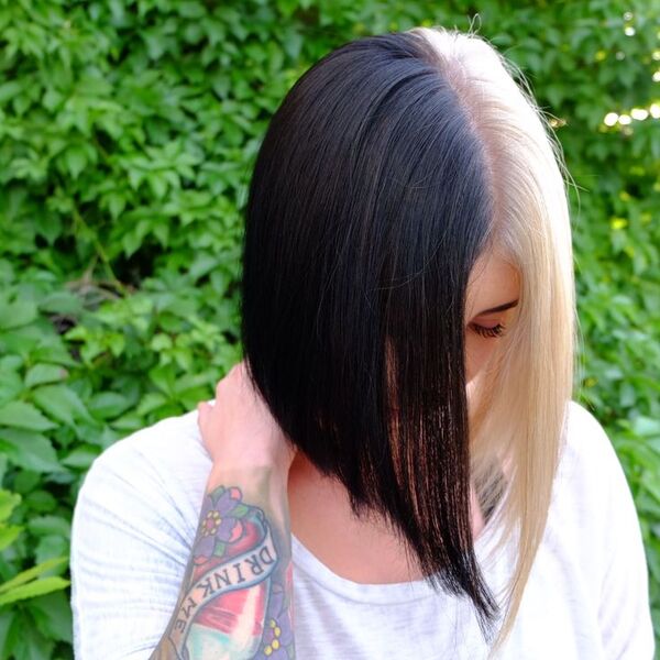 half black half platinum hair - a woman with a tattoo in her arm and wearing a white shirt