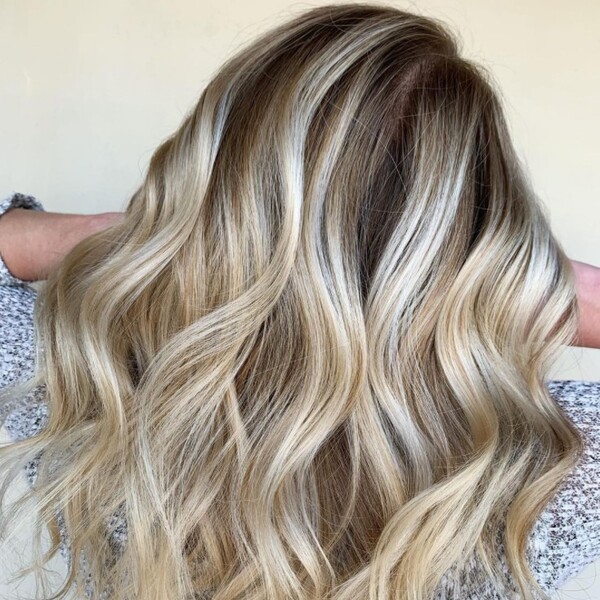 platinum ombre with brown roots - a white young woman wearing a floral shirt