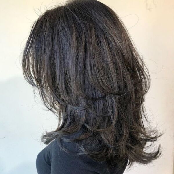 voluminous wolf cut for fine hair - a woman wearing a fitted turtle neck shirt