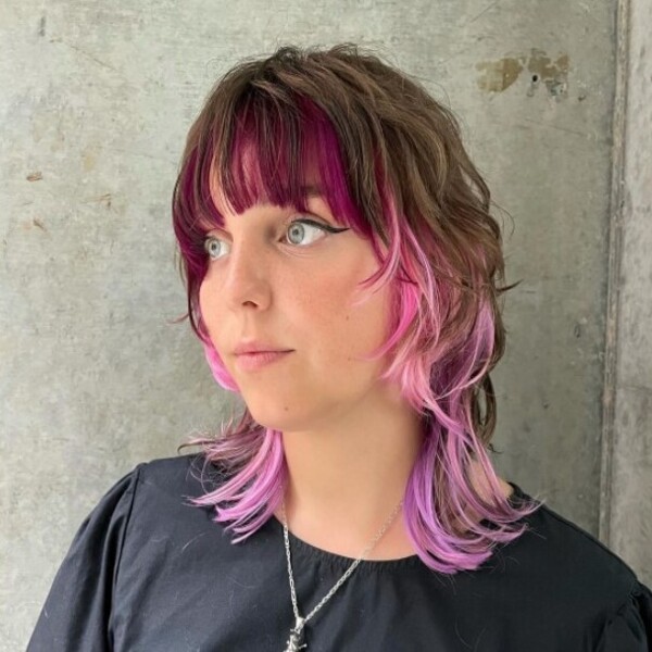 wolf cut hairstyle with pink highlights - a girl wearing a necklace and a black shirt