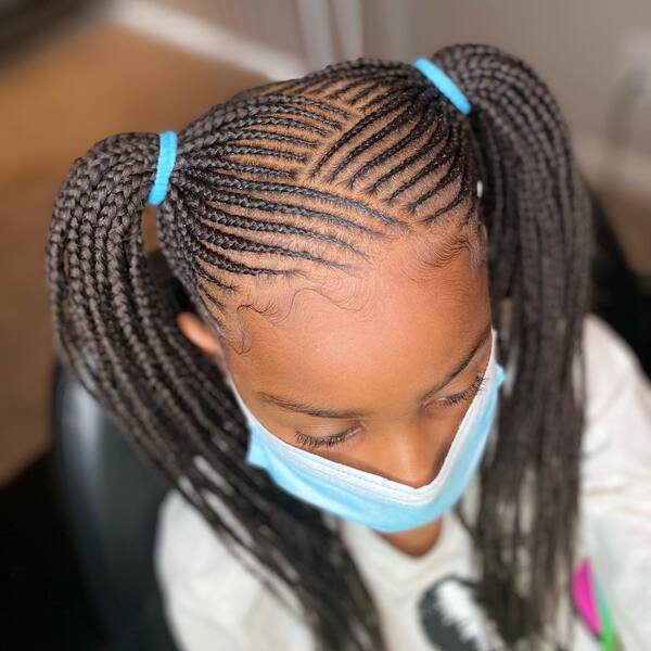 2 Ponytail 4-9 Small Knotless Braids - A woman wearing a color gray sweater and a face mask