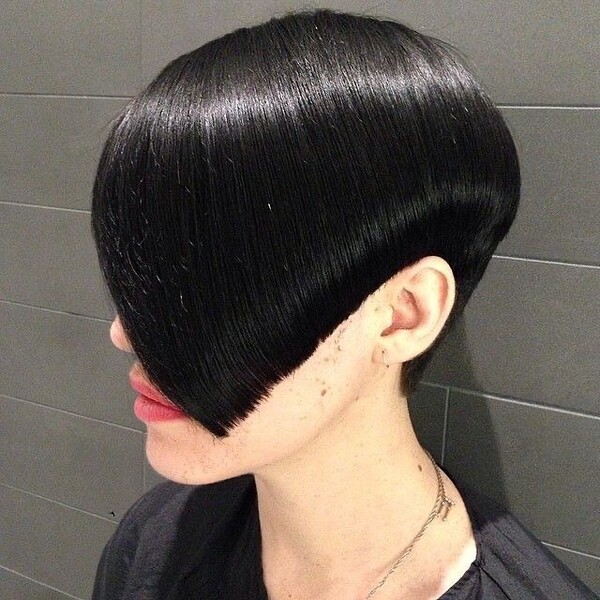 Asymmetrical Bob Pixie Hair - A woman wearing a black salon cape