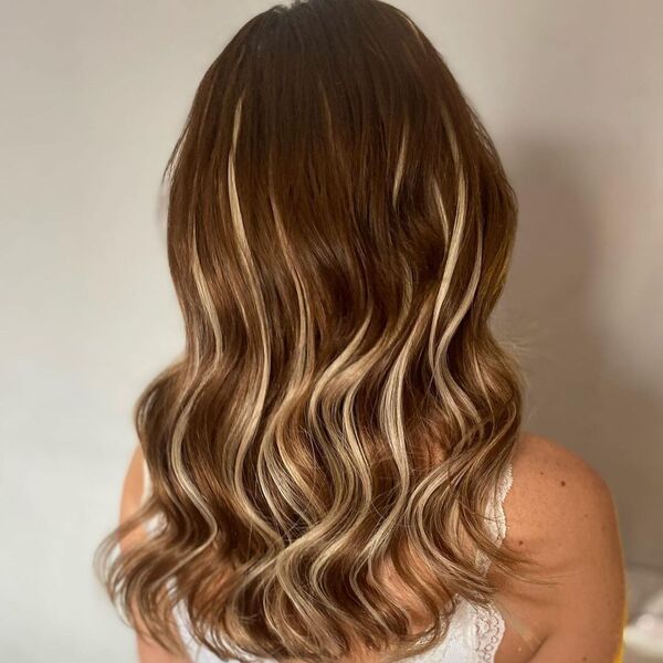 Balayage Weave Hairstyle - A woman wearing a white sexy top