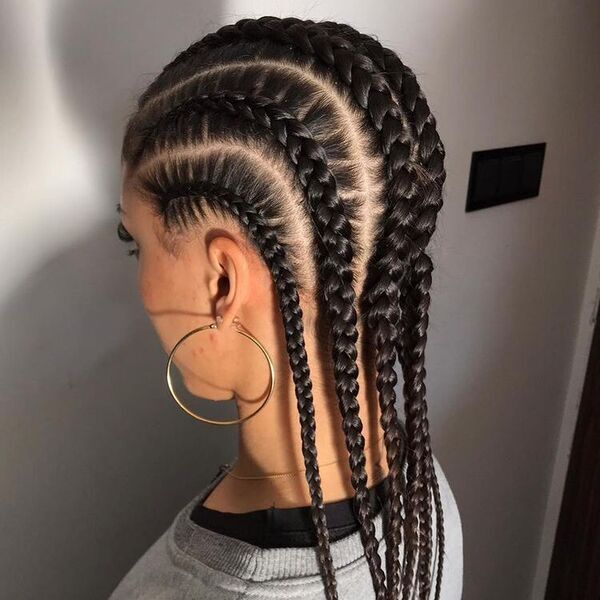 Black Hair Braided Cornrow - A woman wearing big circle earrings and a color gray sweat shirt