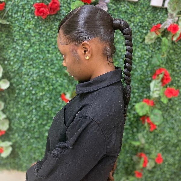 Black Hair Sleek Ponytail Braids - A woman wearing a long sleeve polo shirt