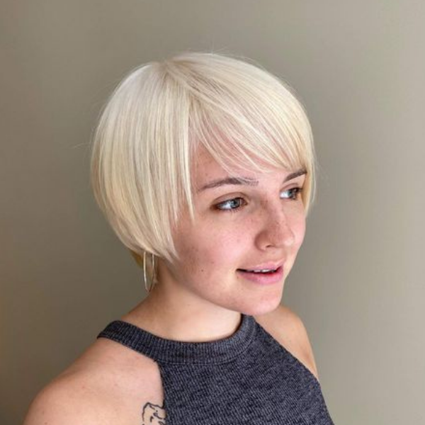 Blonde Bob Pixie with Two Sided Bangs - A woman with a tattoo