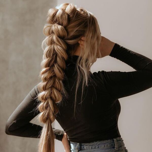 Blonde Hair Butterfly Ponytail Braids - A woman wearing a black turtle neck long sleeve