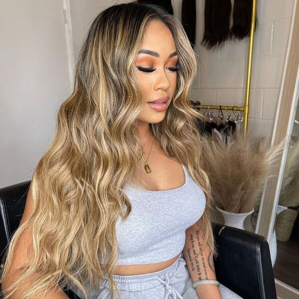 Blonde Long Hairstyle - A woman wearing a gray terno top and pants