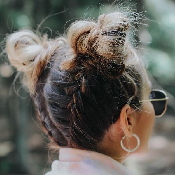 Braided Space Buns - a woman wearing a sunglasses and earrings