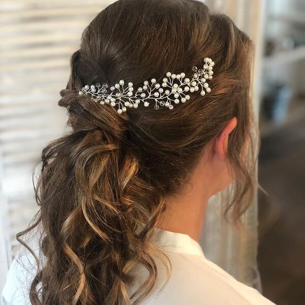 Bridal Ponytail - A woman with hair decor wearing a white blouse