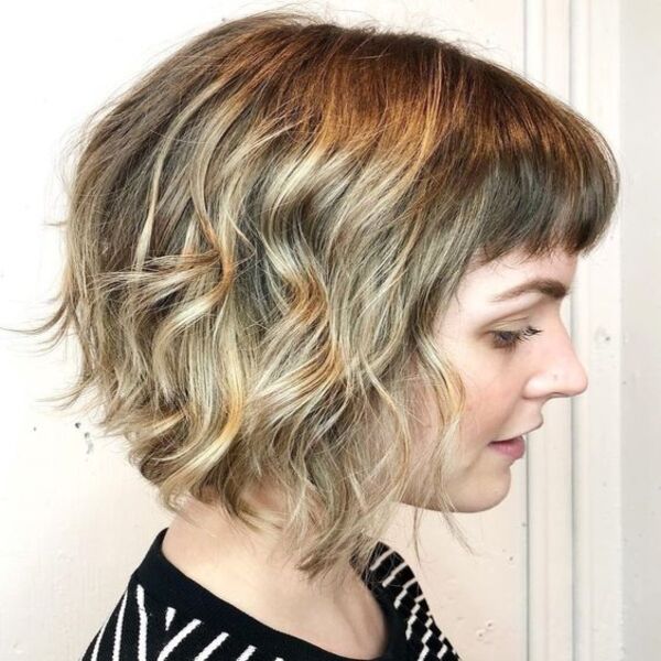 Brown Base with Light Blonde Balayage Shag Hair - A woman in her black and white stripe top